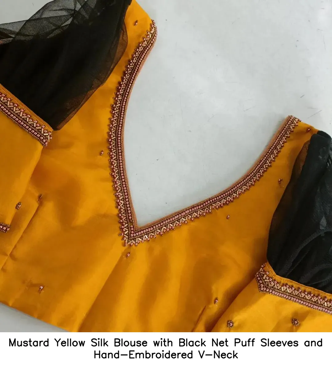 ​​​Mustard Yellow Silk Blouse with Black Net Puff Sleeves and Hand-Embroidered V-Neck