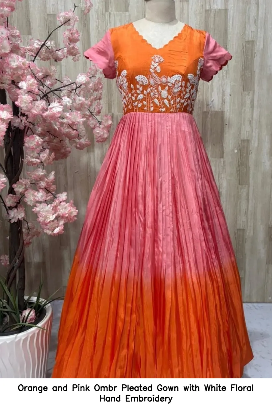 orange and pink ombre pleated gown with white floral hand embroidery
