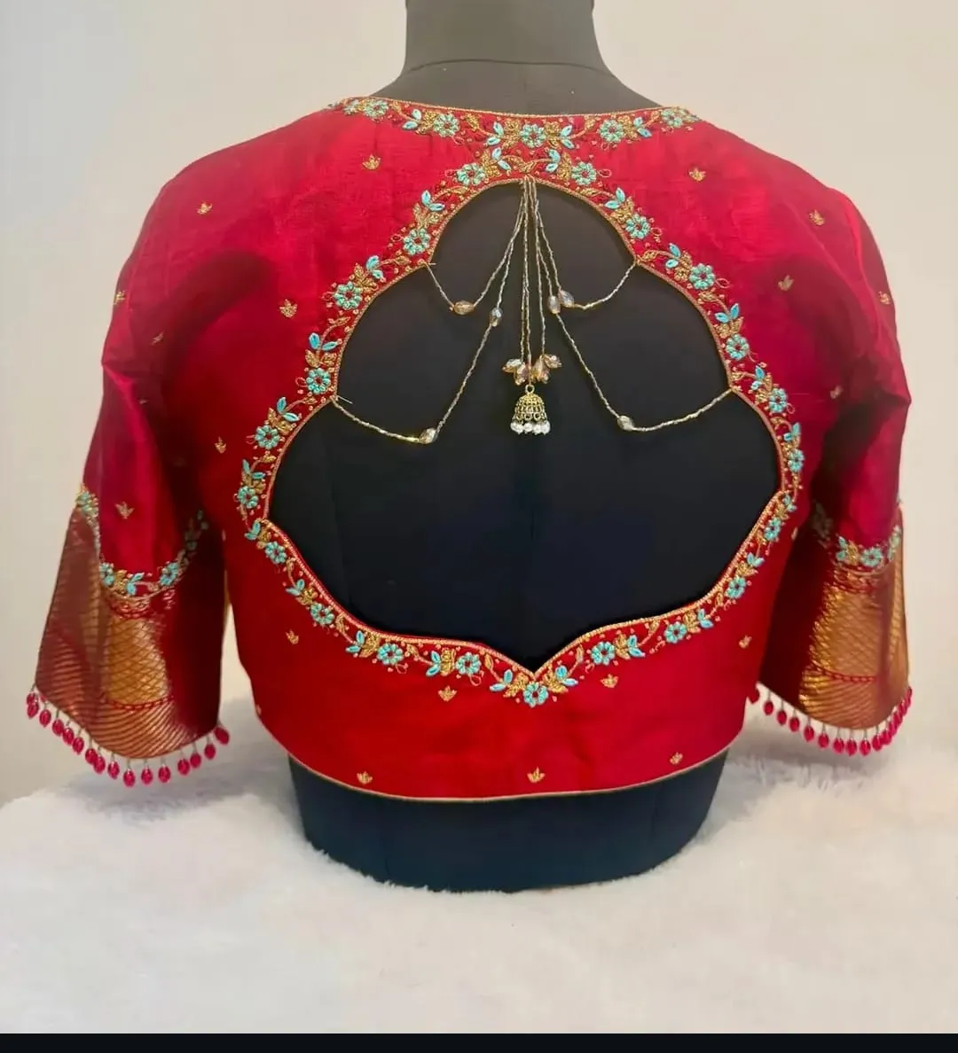 Crimson Red Silk Saree Blouse with Turquoise Aari Work, Jhumka Tassel Cutout Back & Zari Border Sleeves 1