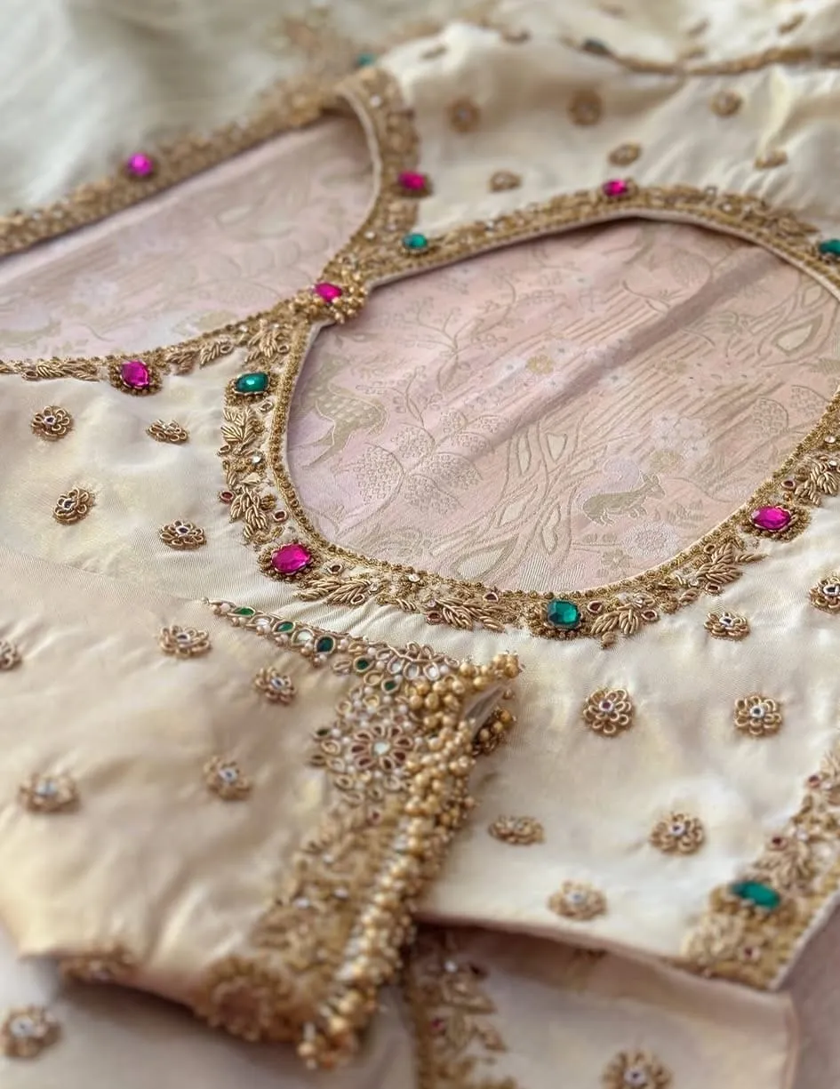 Off-White Raw Silk Bridal Saree Blouse – Sweetheart Neck Maggam Work with Emerald & Pink Stone Border & Cluster Pearl Sleeves