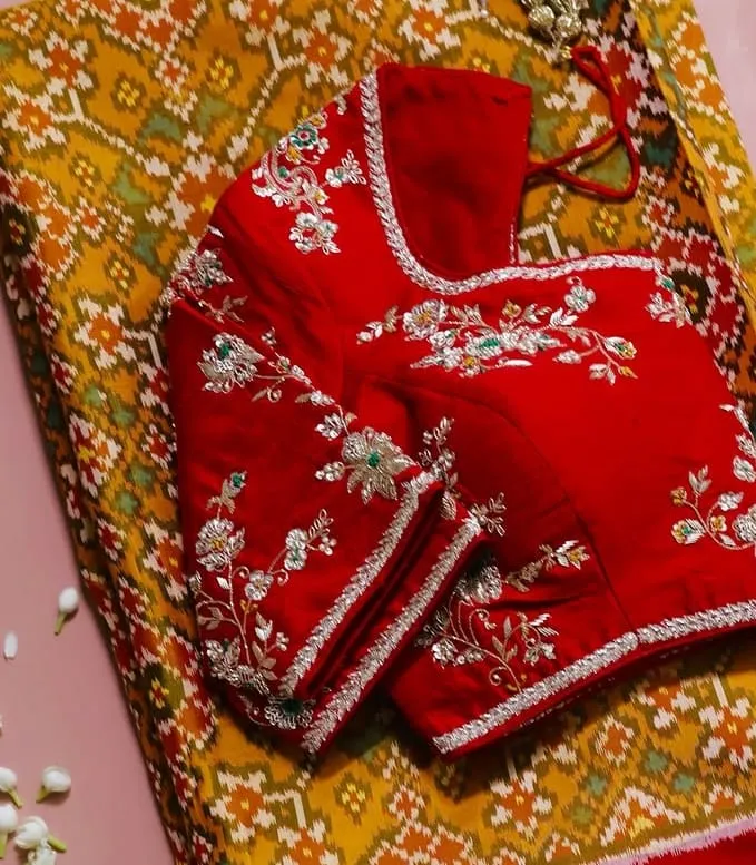 Bridal Red Silk Maggam Work Blouse | Handcrafted Silver Zari & Emerald Floral Aari Blouse