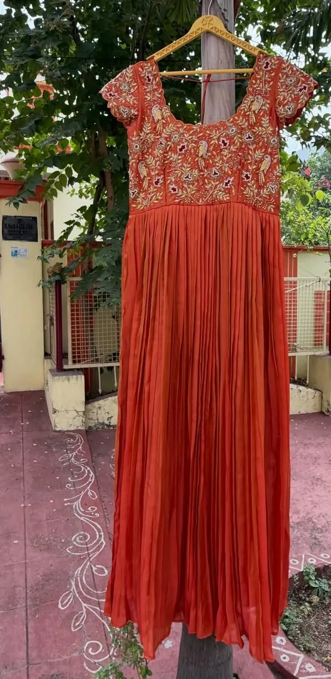Rust Orange Pleated Gown with Hand Embroidered Parrot Motif